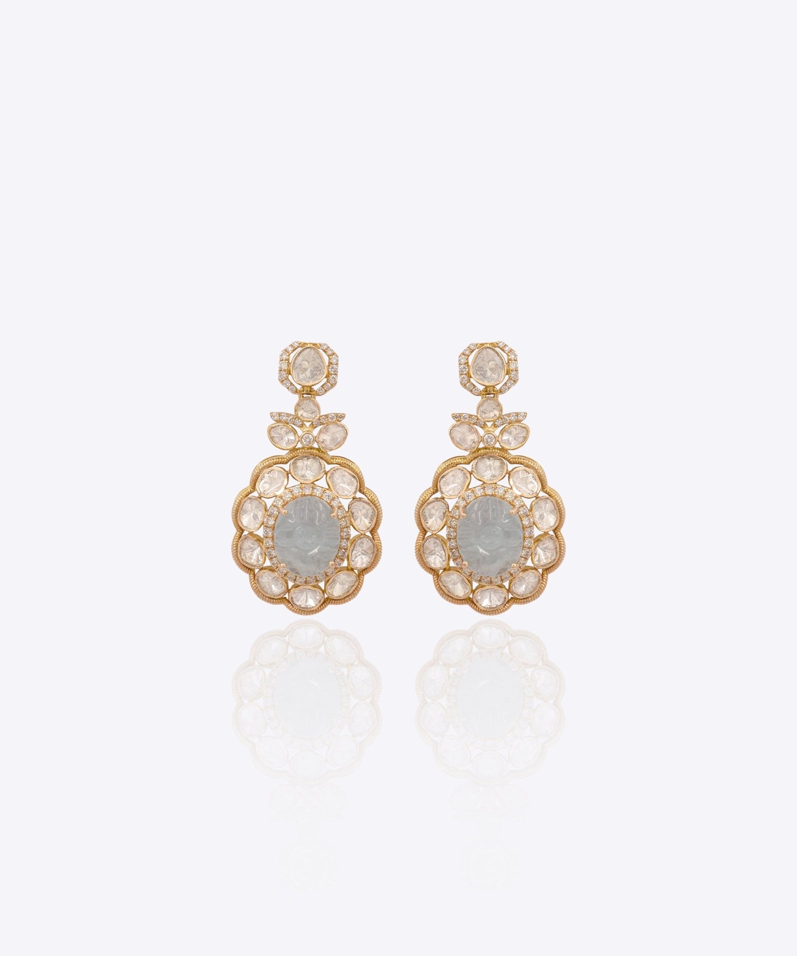Antique gold Polki earrings photographed flat with emerald drops for wedding wear.