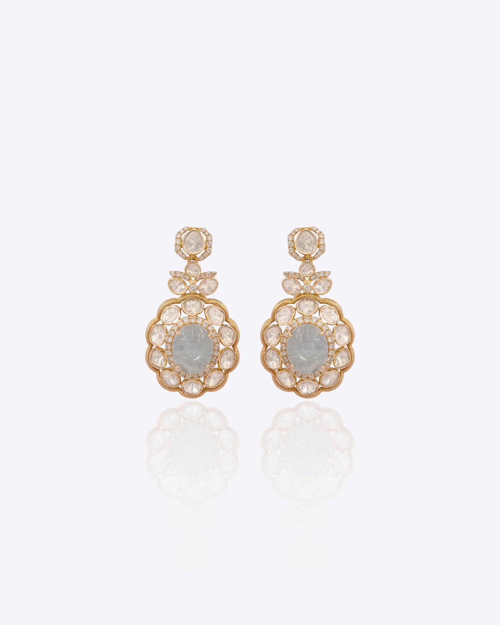 Antique gold Polki earrings photographed flat with emerald drops for wedding wear.