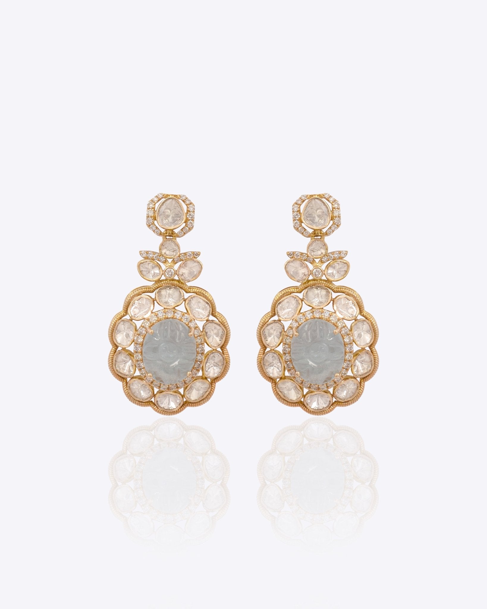 14K gold drop earrings with carved aquamarine centers and Polki diamond accents.