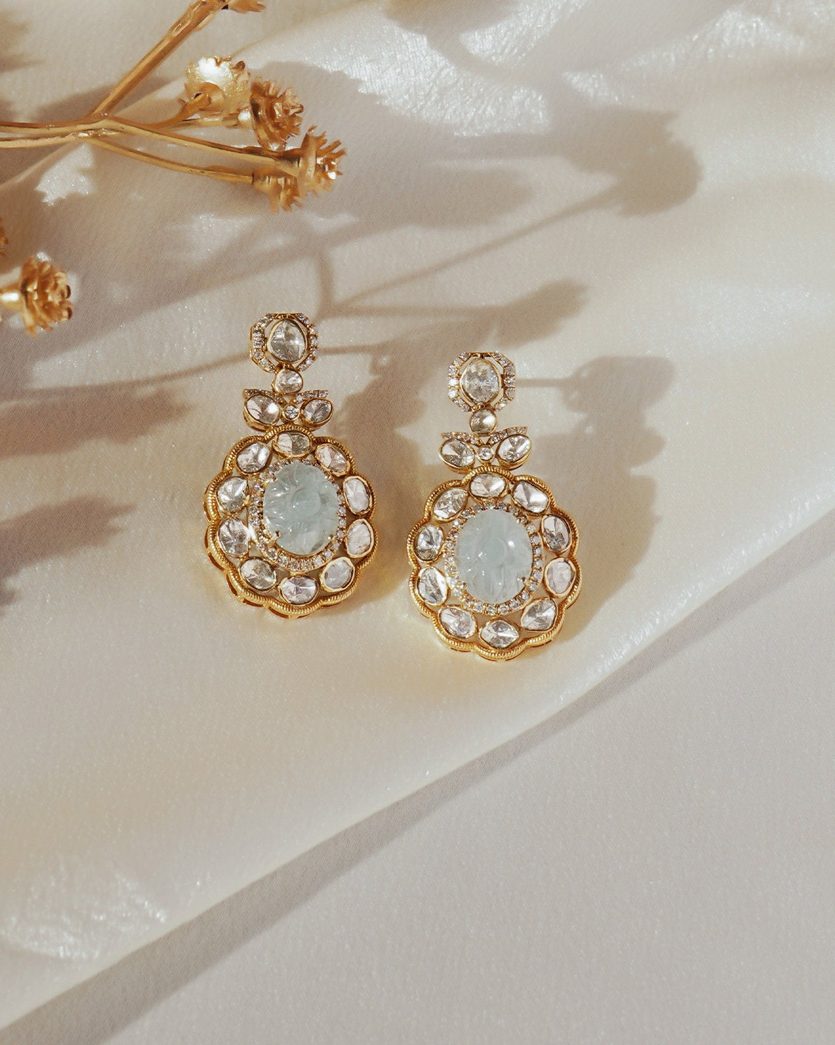14K gold drop earrings with carved aquamarine centers and Polki diamond accents.
