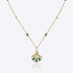 9k gold Tropical Plume necklace with fan pendant, elegant Polki center, and emerald arc detailing