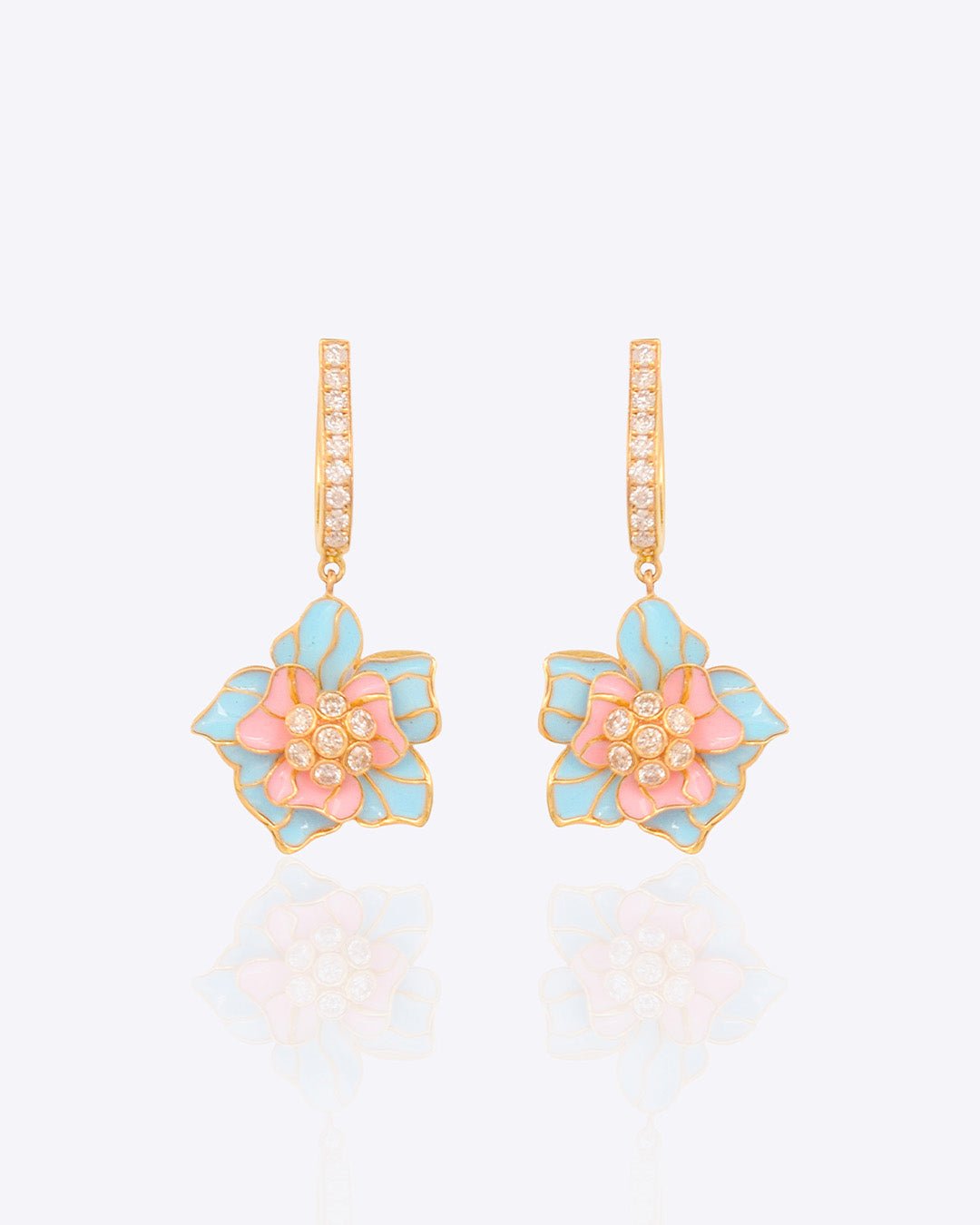 Detailed view of earrings with gemstone and polki fusion in royal gold tones.