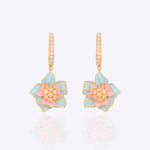 Detailed view of earrings with gemstone and polki fusion in royal gold tones.