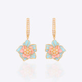 Detailed view of earrings with gemstone and polki fusion in royal gold tones.