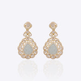 14K gold drop earrings with carved aquamarine petals and fine Polki diamond accents.