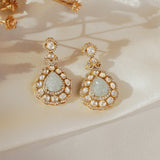 14K gold drop earrings with carved aquamarine petals and fine Polki diamond accents.