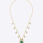 14K gold pendant with emerald centerpiece and diamond-studded bow