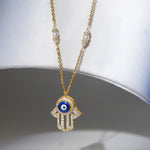 14k gold necklace with an Evil Eye and Hamsa symbol in diamonds