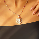Rose-toned Polki pendant in 14K gold with soft pink stone drop, styled for evening wear.