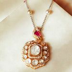 Rose-toned Polki pendant in 14K gold with soft pink stone drop, styled for evening wear.