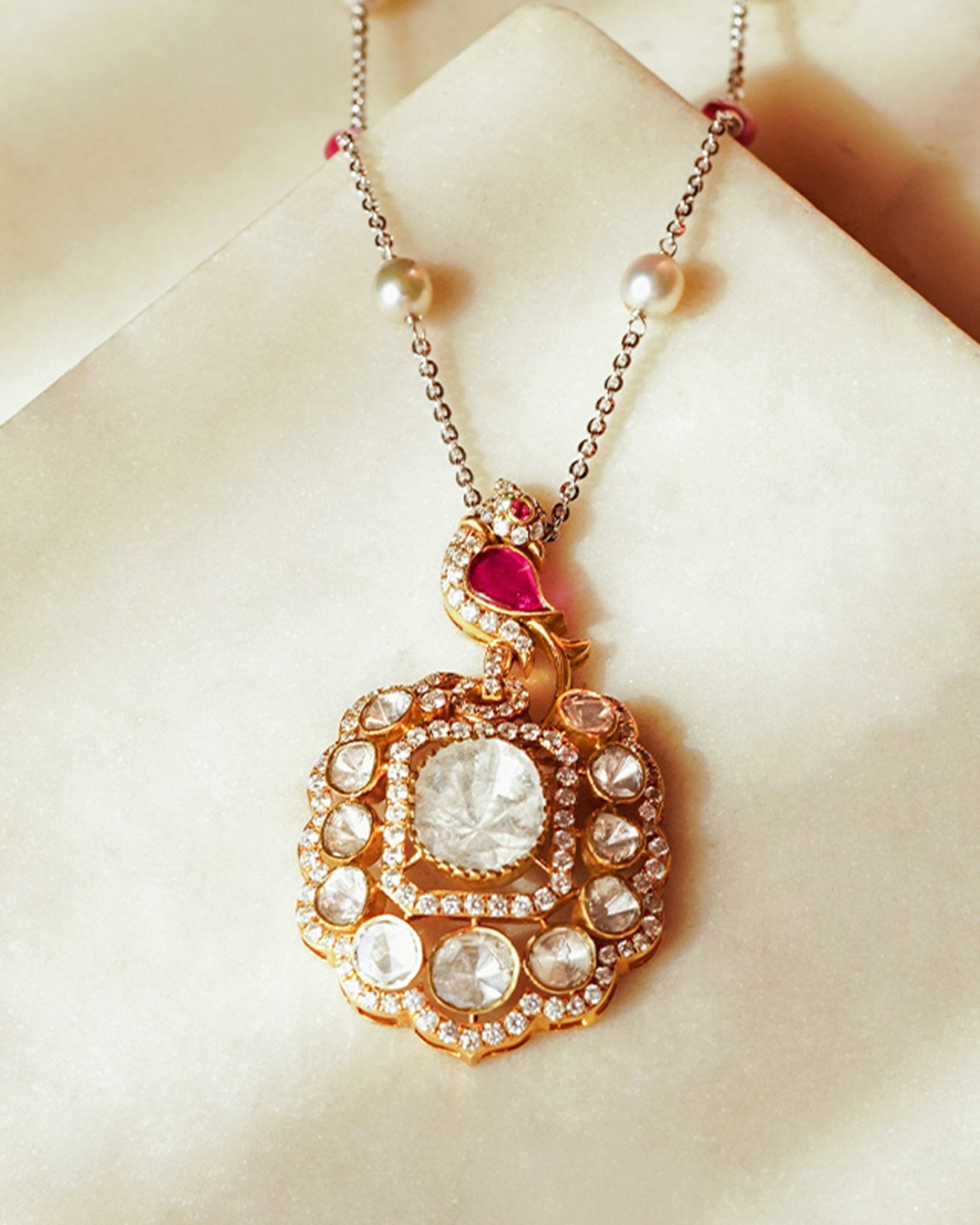 Rose-toned Polki pendant in 14K gold with soft pink stone drop, styled for evening wear.