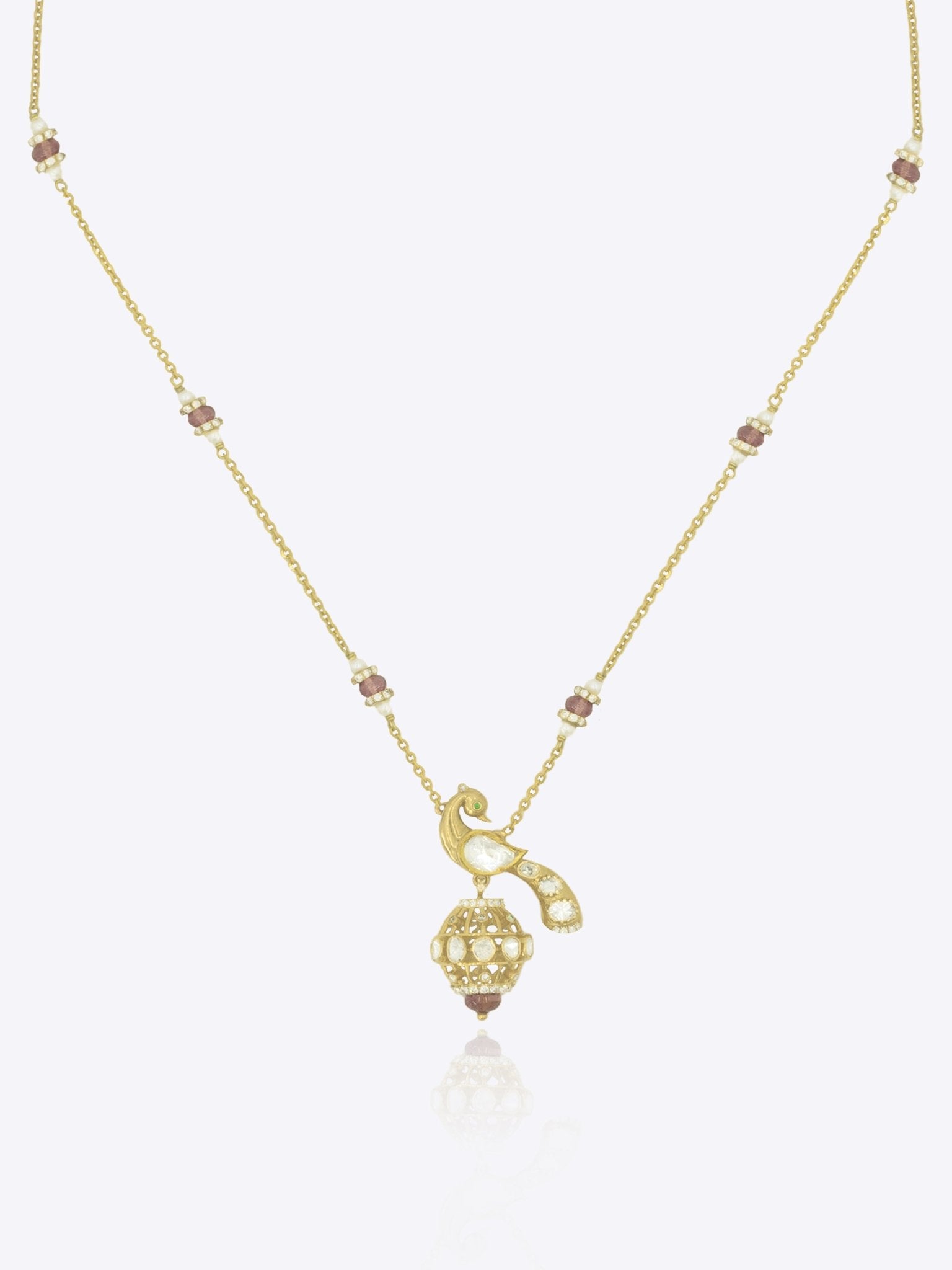 14K gold peacock-inspired pendant featuring luminous Polki accents with delicate moonlit brilliance.