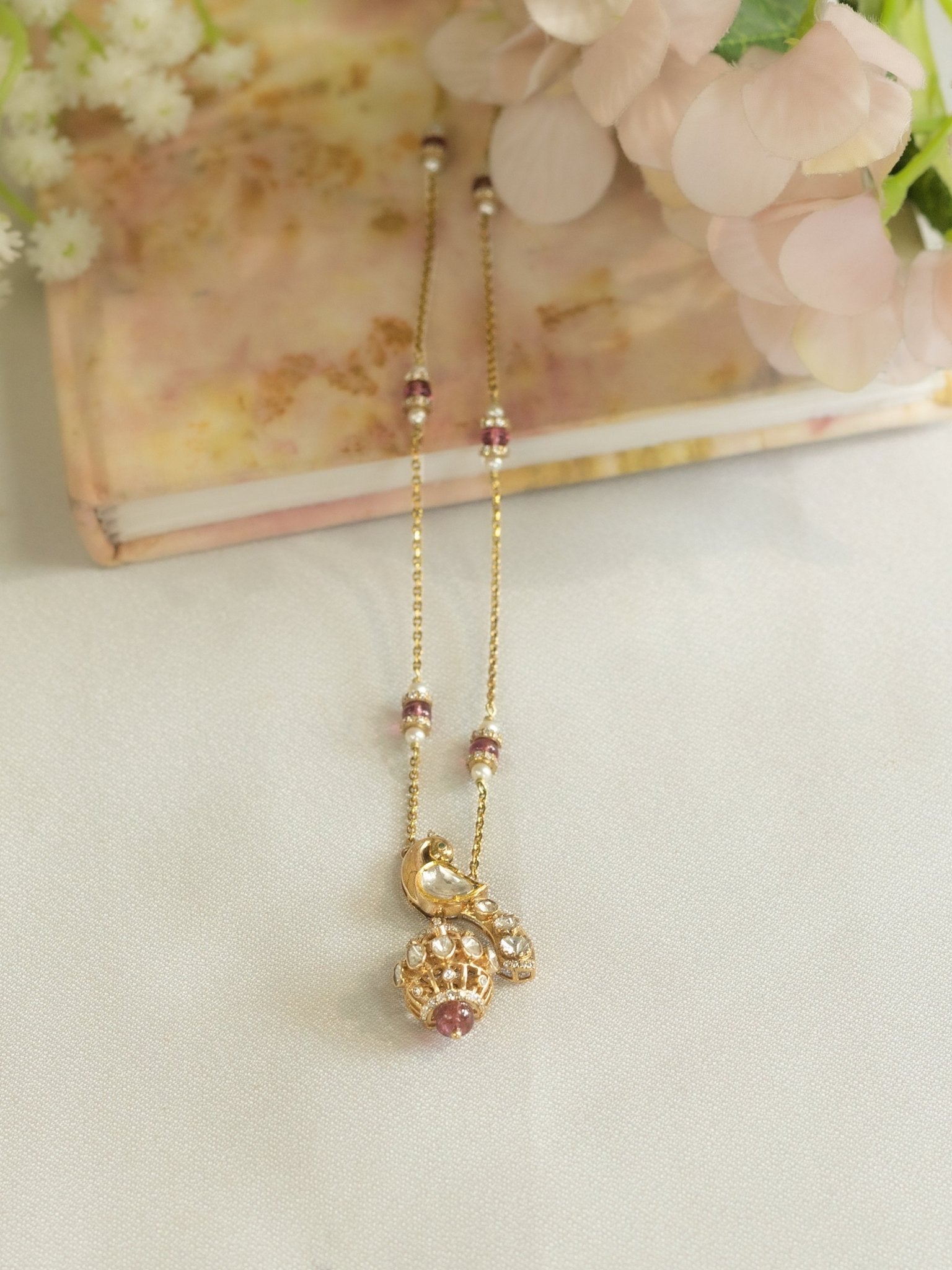 14K gold peacock-inspired pendant featuring luminous Polki accents with delicate moonlit brilliance.