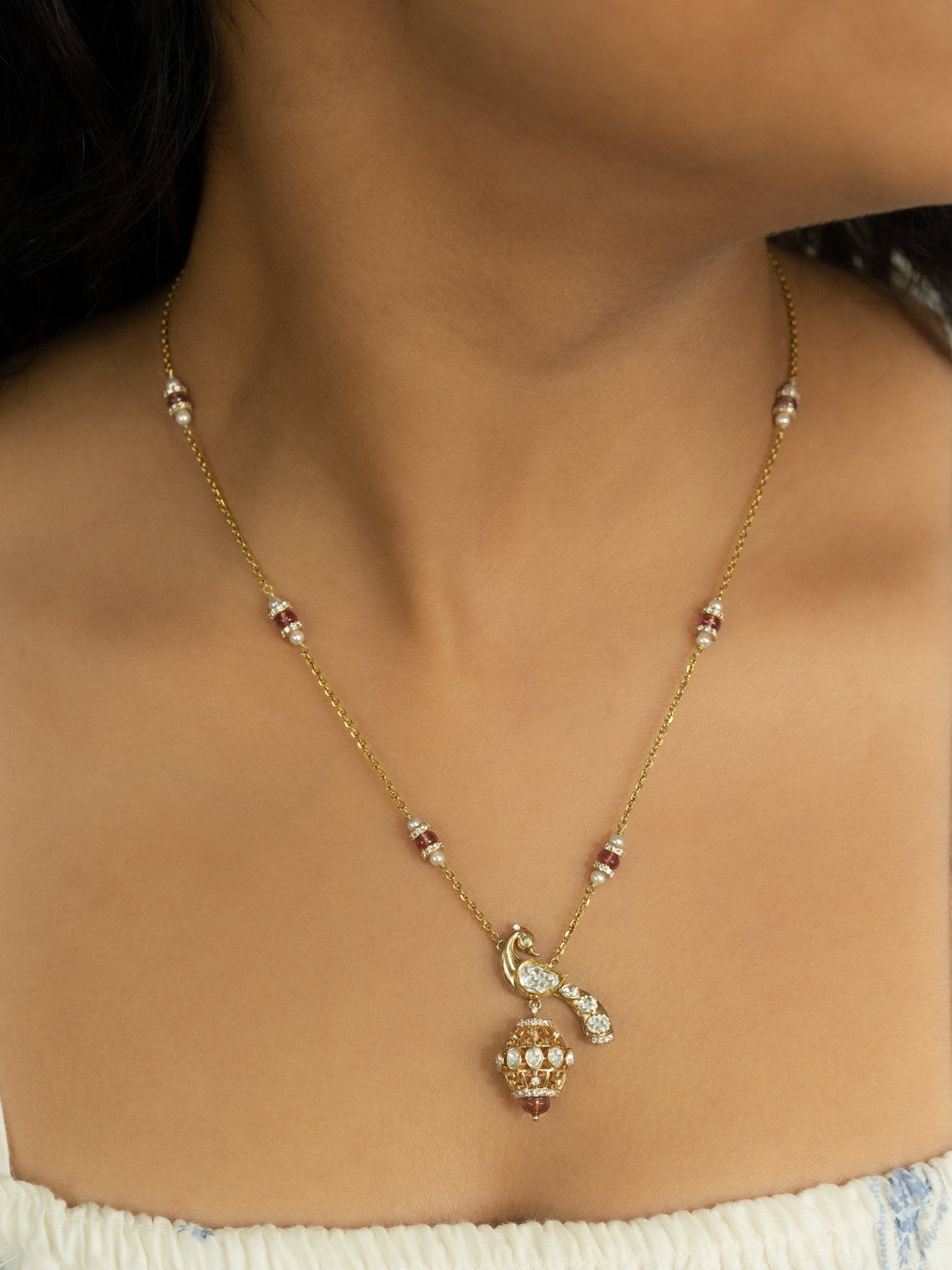 14K gold peacock-inspired pendant featuring luminous Polki accents with delicate moonlit brilliance.
