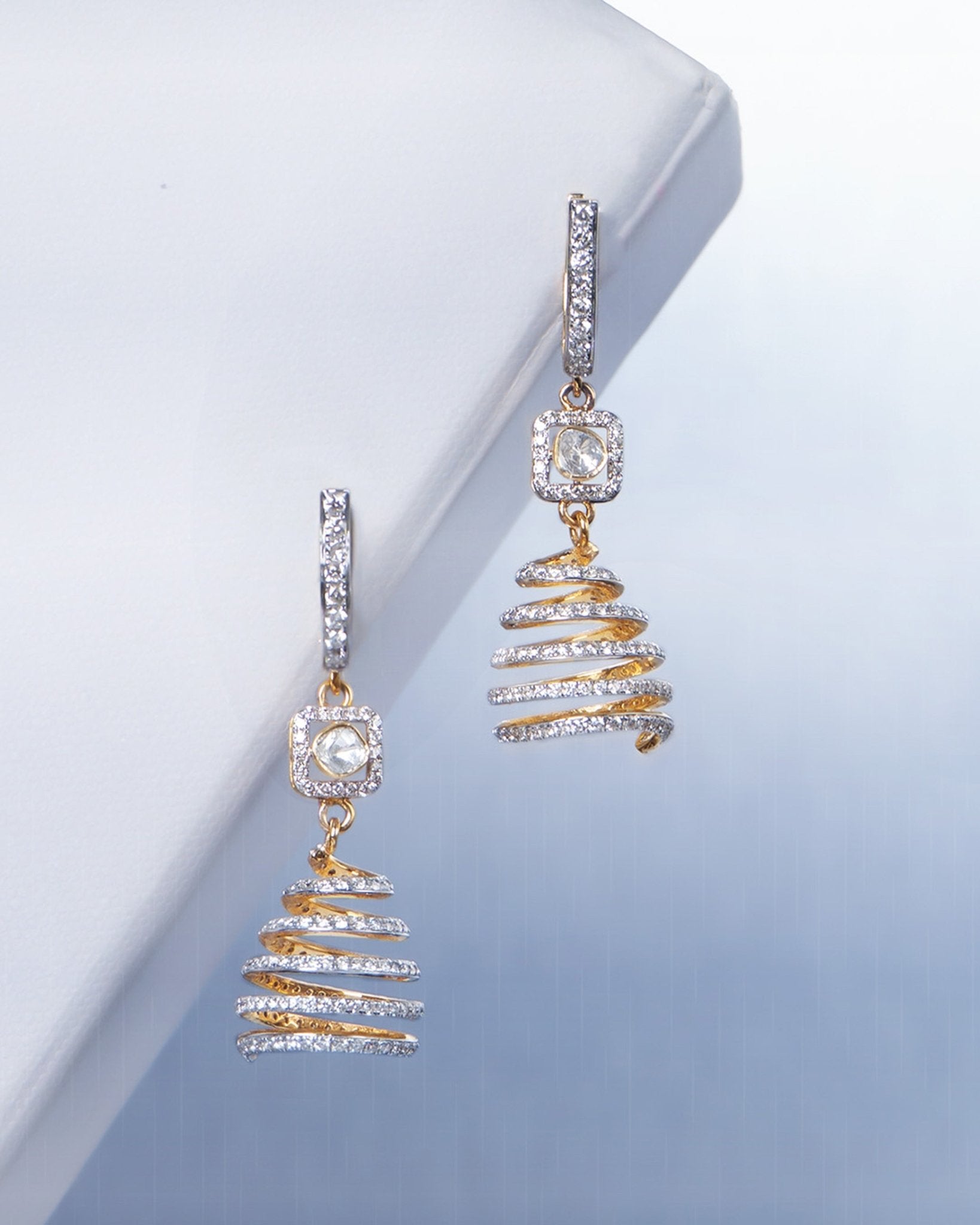 14k gold spiral earrings with Polki diamonds in a sculptural helix design.
