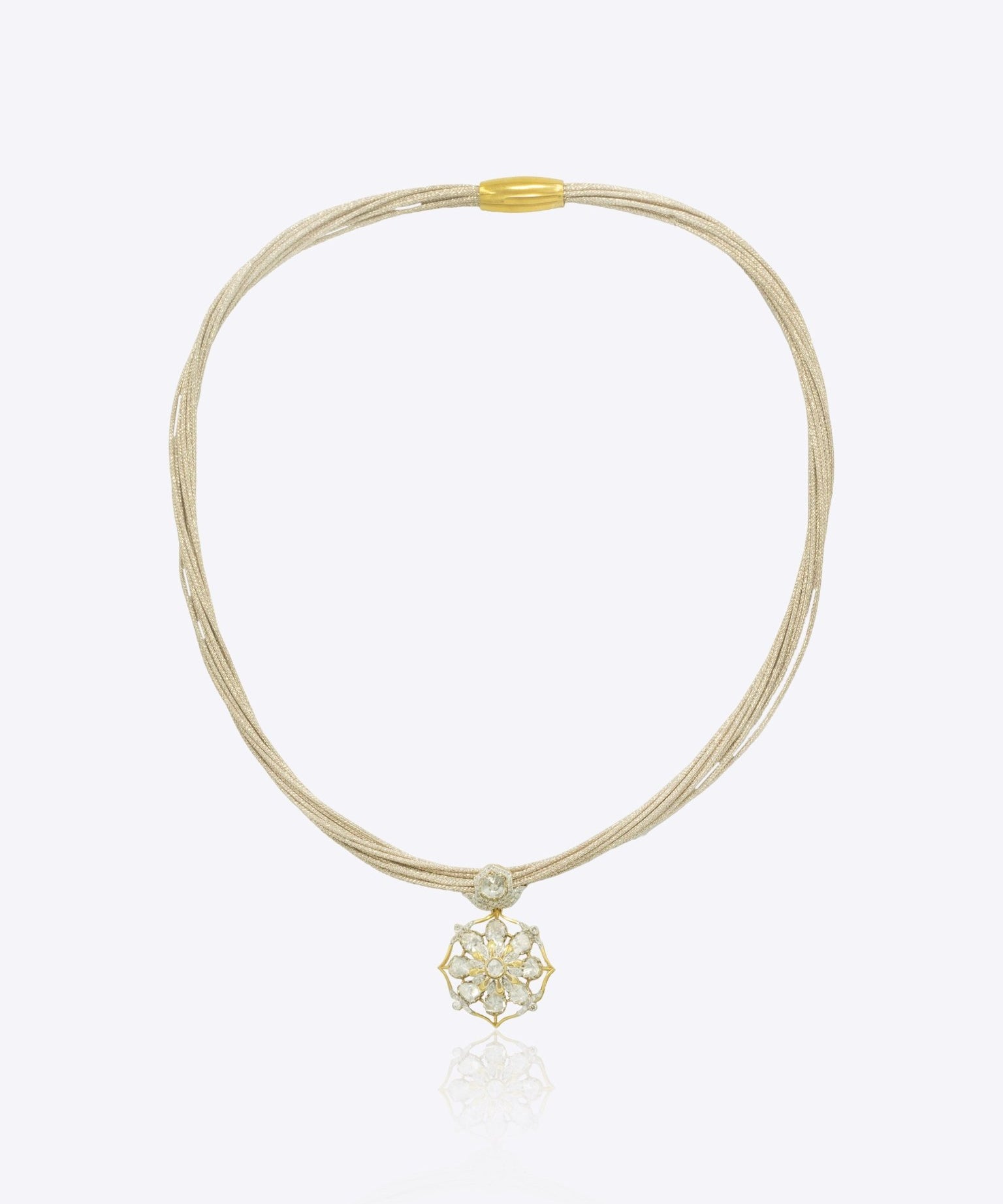 9k gold elegant thread necklace with floral centerpiece and emerald Polki design
