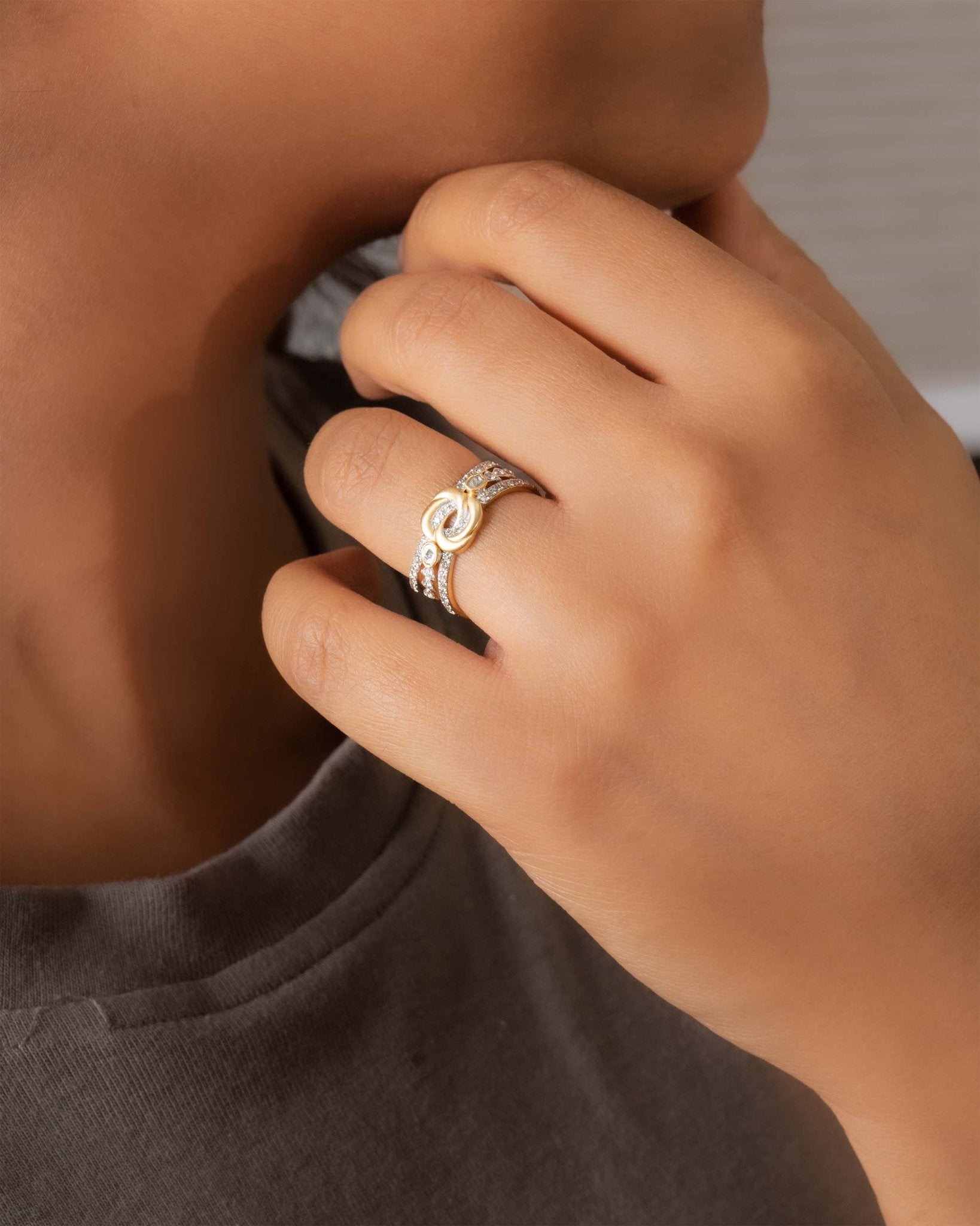 14K gold ring with an interwoven knot design set with Polki diamonds.