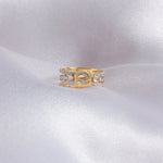 14K gold ring with an interwoven knot design set with Polki diamonds.