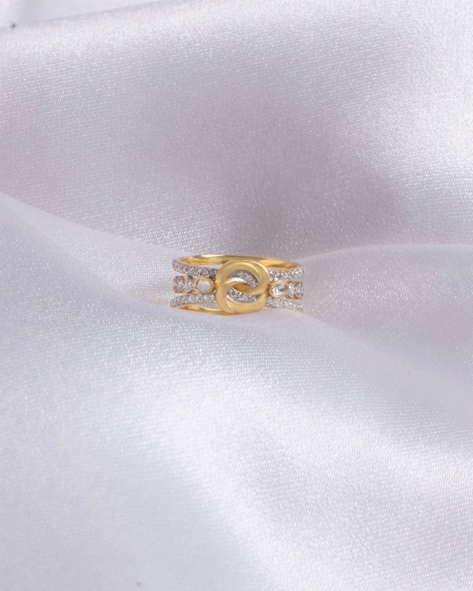14K gold ring with an interwoven knot design set with Polki diamonds.