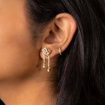 14K gold drop earrings with pear-shaped stones and knot motif