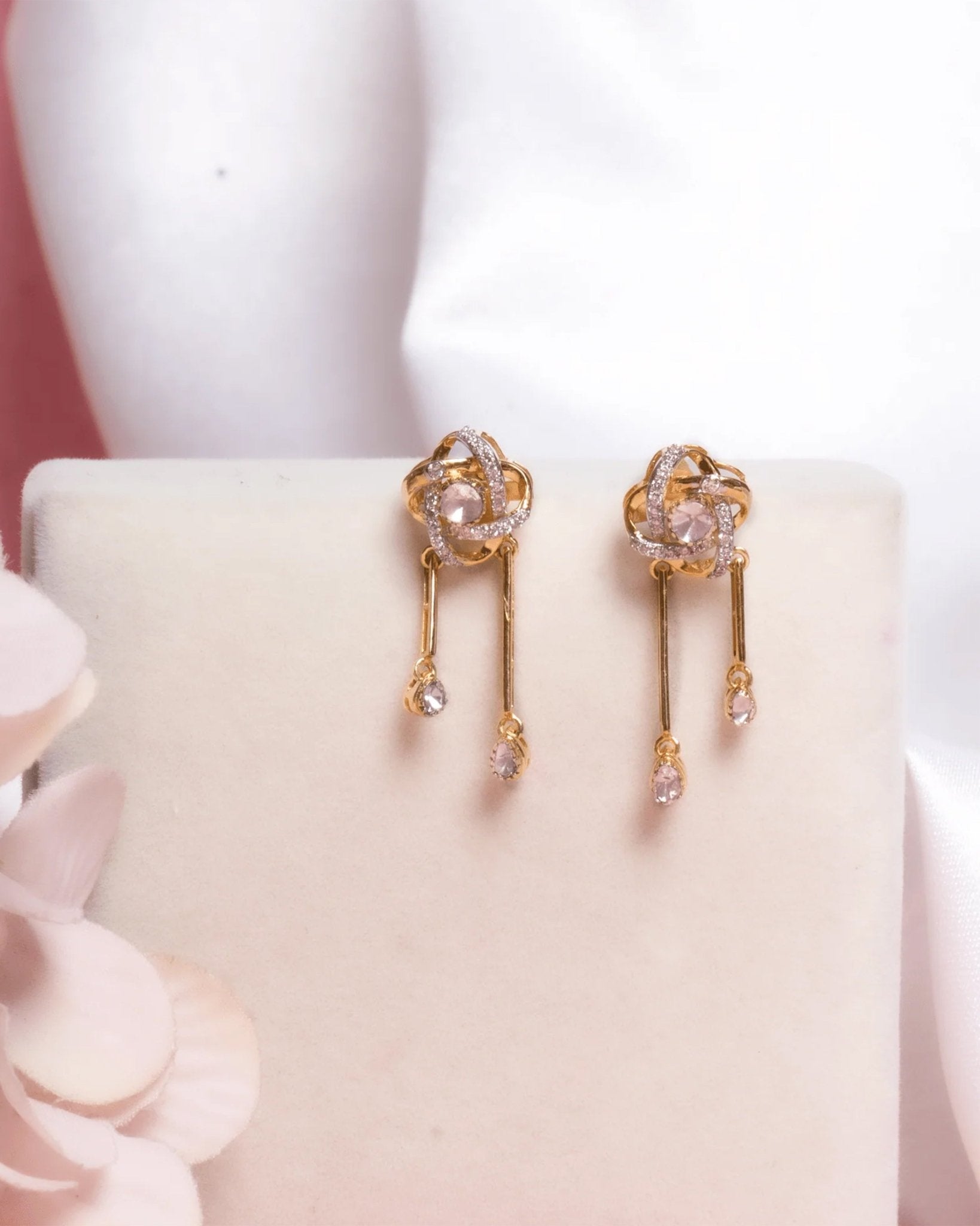 14K gold drop earrings with pear-shaped stones and knot motif