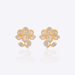 18K gold floral stud earrings with a Polki bloom and gold leaf accent.