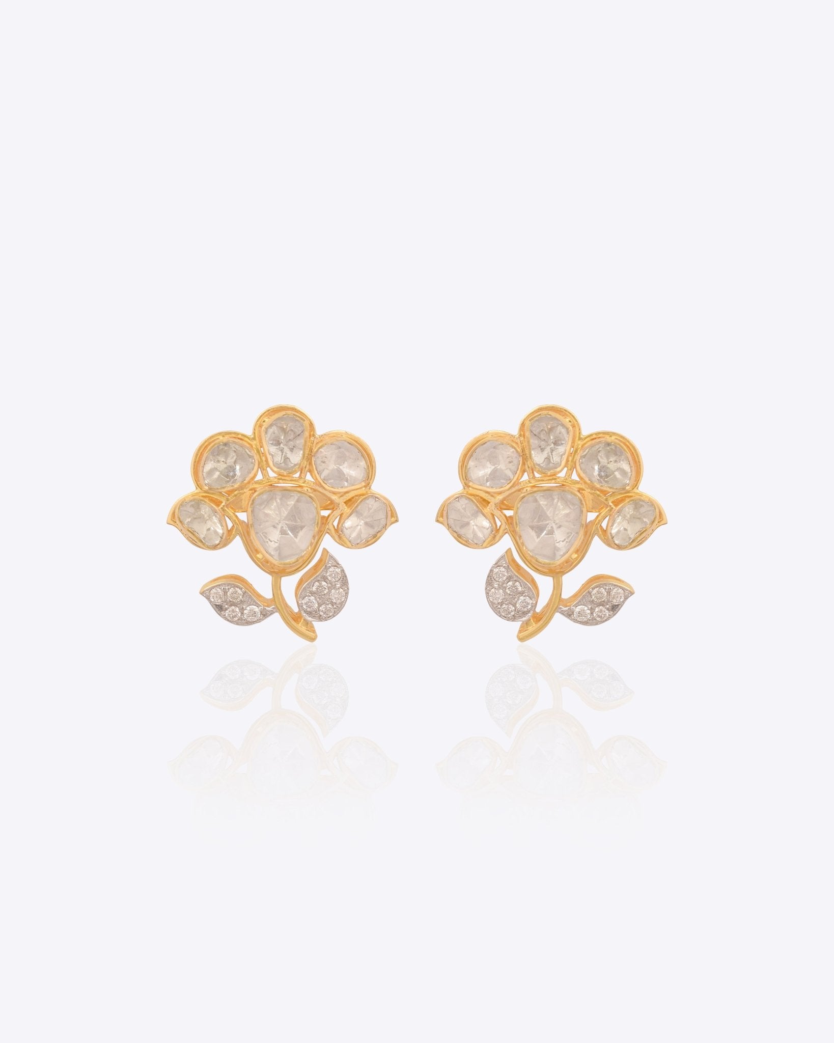 18K gold floral stud earrings with a Polki bloom and gold leaf accent.