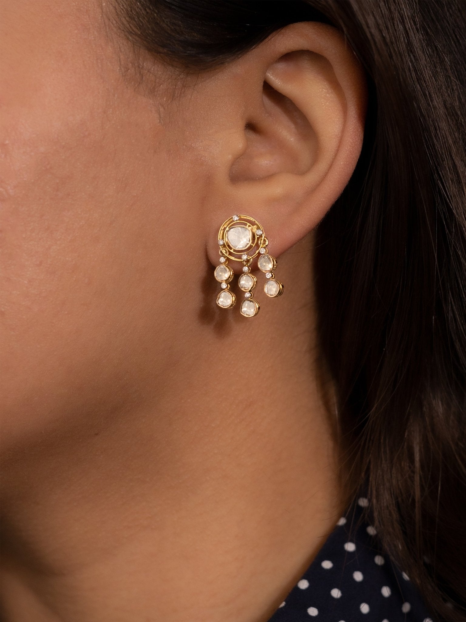 Glowfall Earrings featuring luminous Polki stones with delicate detailing and cascading drop design.