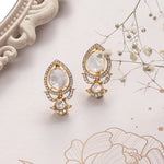 14K gold earrings with Polki and diamond oval layering for festive sparkle.