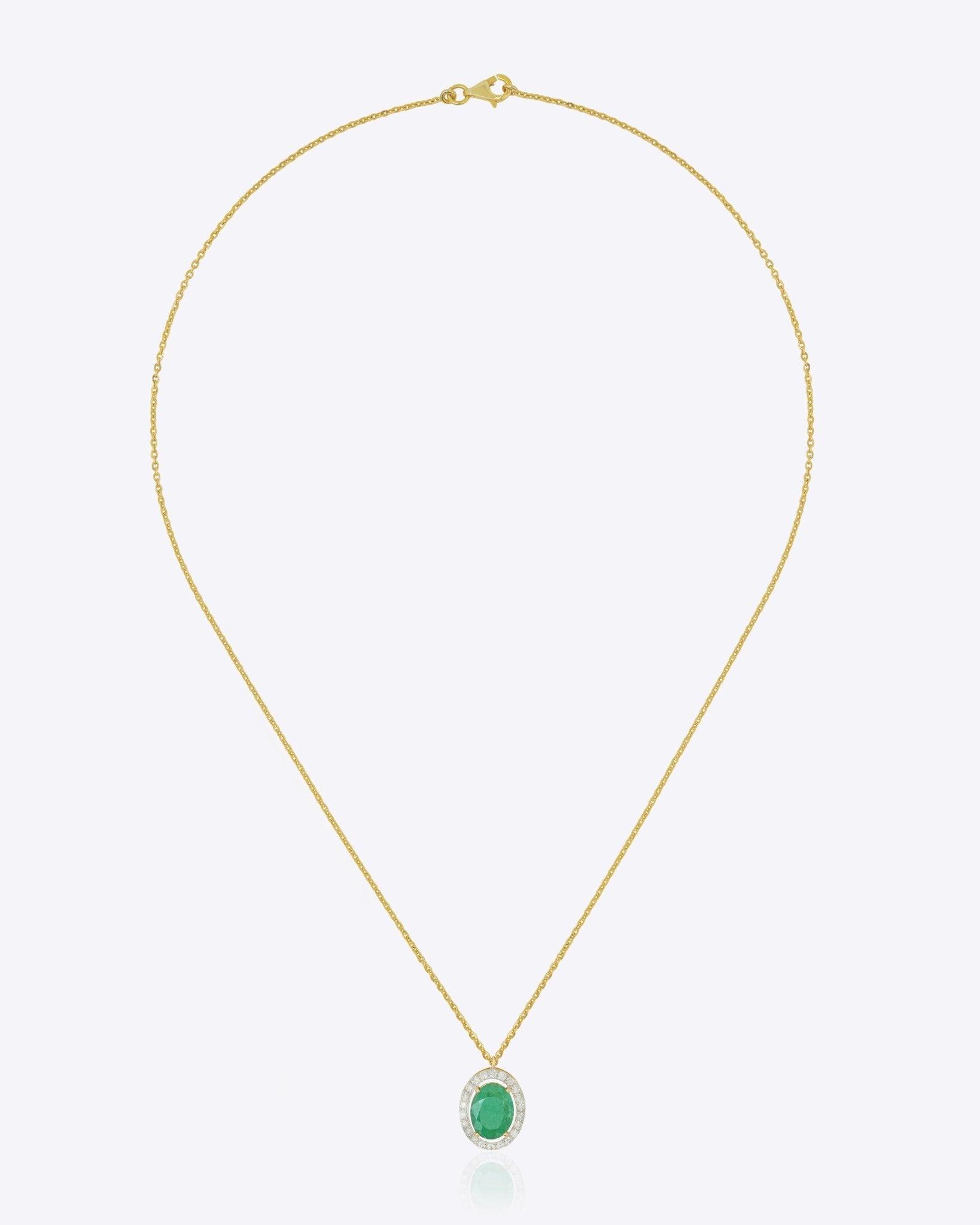 Oval emerald pendant in warm gold with a minimal, refined design