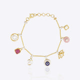 14k gold charm bracelet with Evil Eye, Hamsa, and Om Polki diamond charms