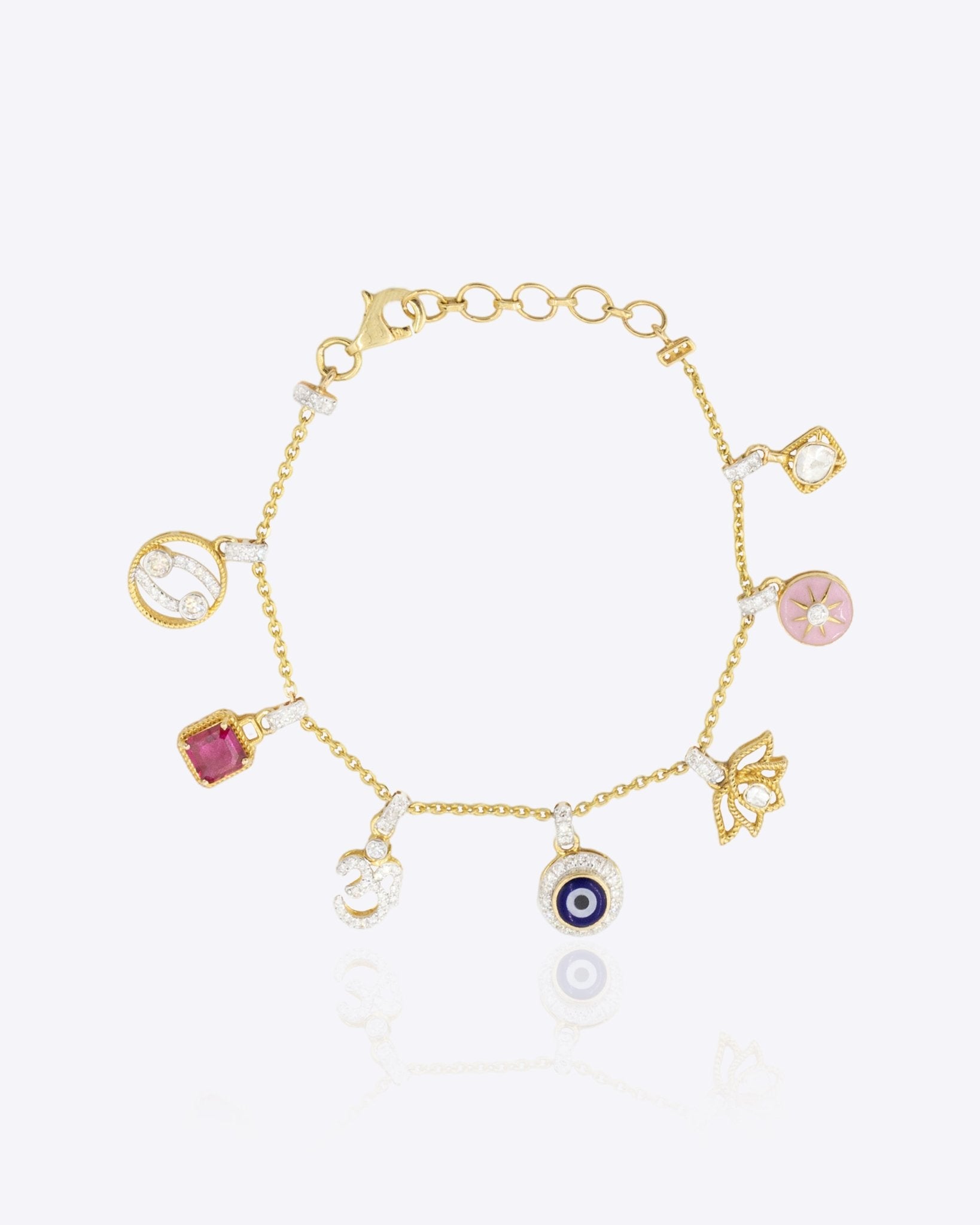 14k gold charm bracelet with Evil Eye, Hamsa, and Om Polki diamond charms