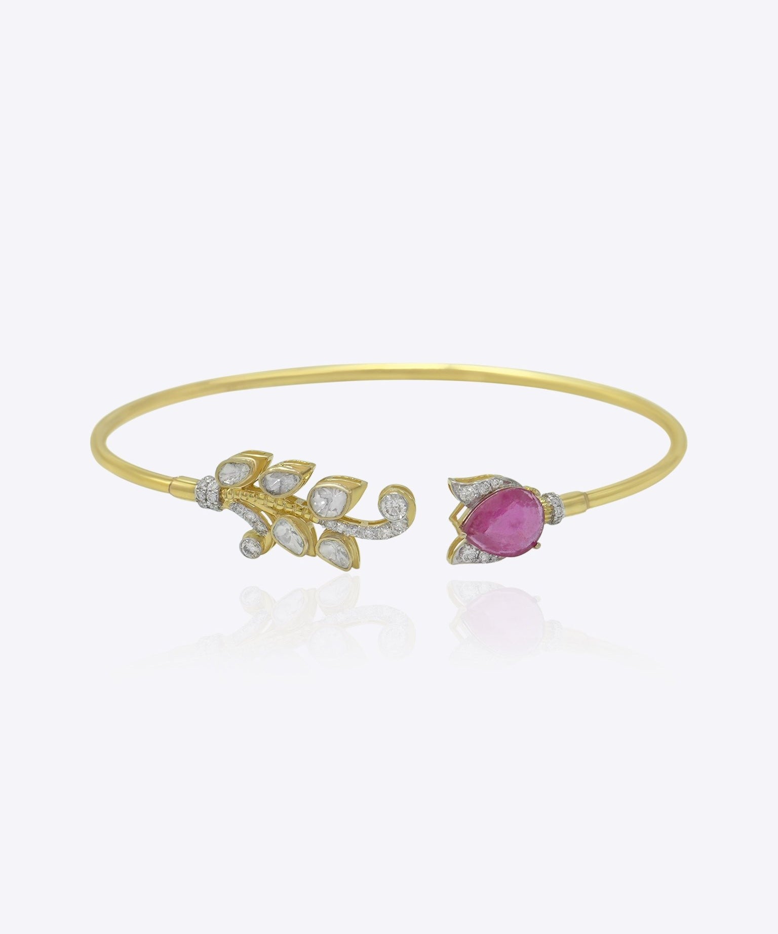Firdous Leaf Bracelet in 9k gold open bypass bracelet featuring a Polki diamond vine and pink gemstone flower.