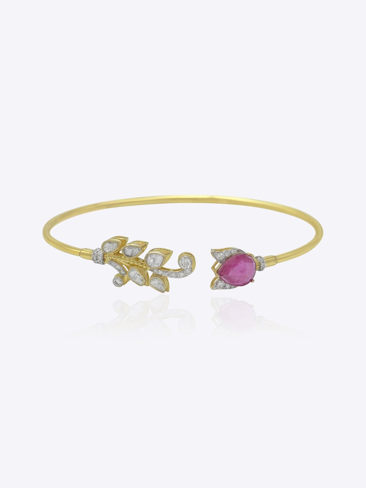 Firdous Leaf Bracelet in 9k gold open bypass bracelet featuring a Polki diamond vine and pink gemstone flower.