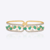 14K gold bracelet with emerald and diamond vine-leaf detailing.
