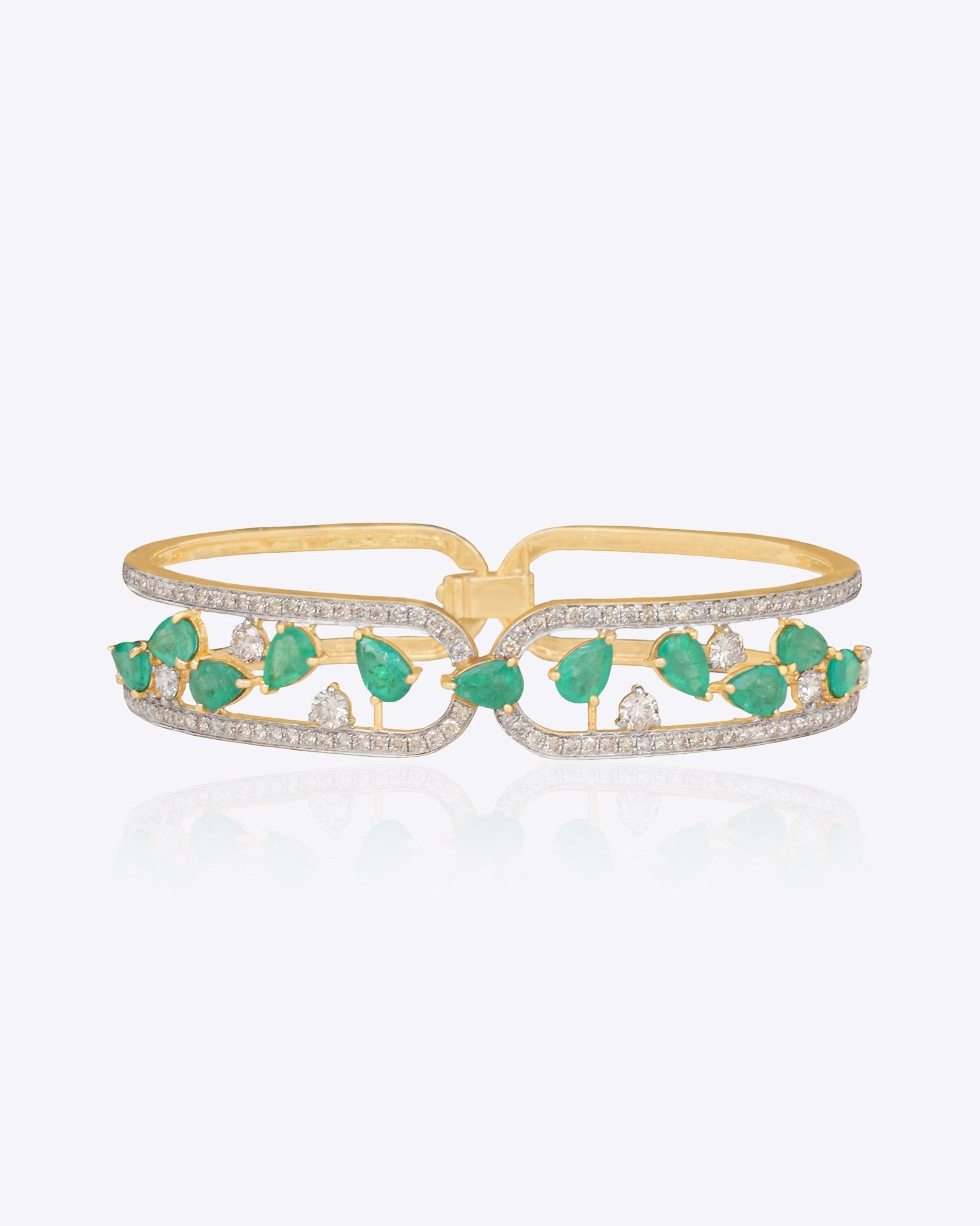14K gold bracelet with emerald and diamond vine-leaf detailing.