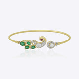 Elegant 9K gold bracelet with curved emerald detailing, sparkling diamonds, and radiant Polki centerpiece