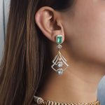 14K gold earrings with a geometric, fluid design