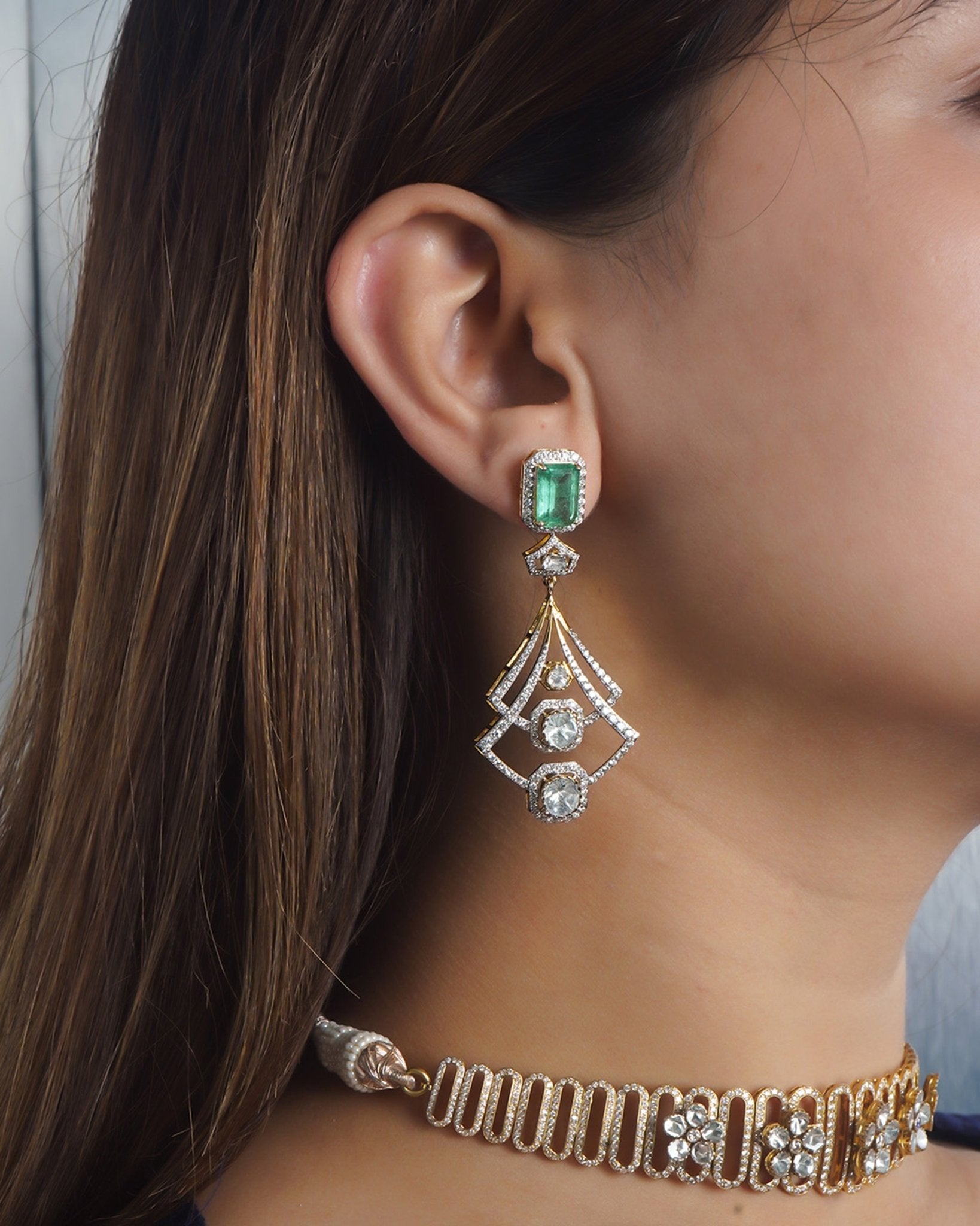 14K gold earrings with a geometric, fluid design