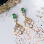 14K gold earrings with a geometric, fluid design