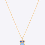 14K gold owl-inspired pendant with Polki diamonds and blue gemstones.