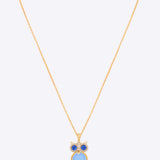14K gold owl-inspired pendant with Polki diamonds and blue gemstones.