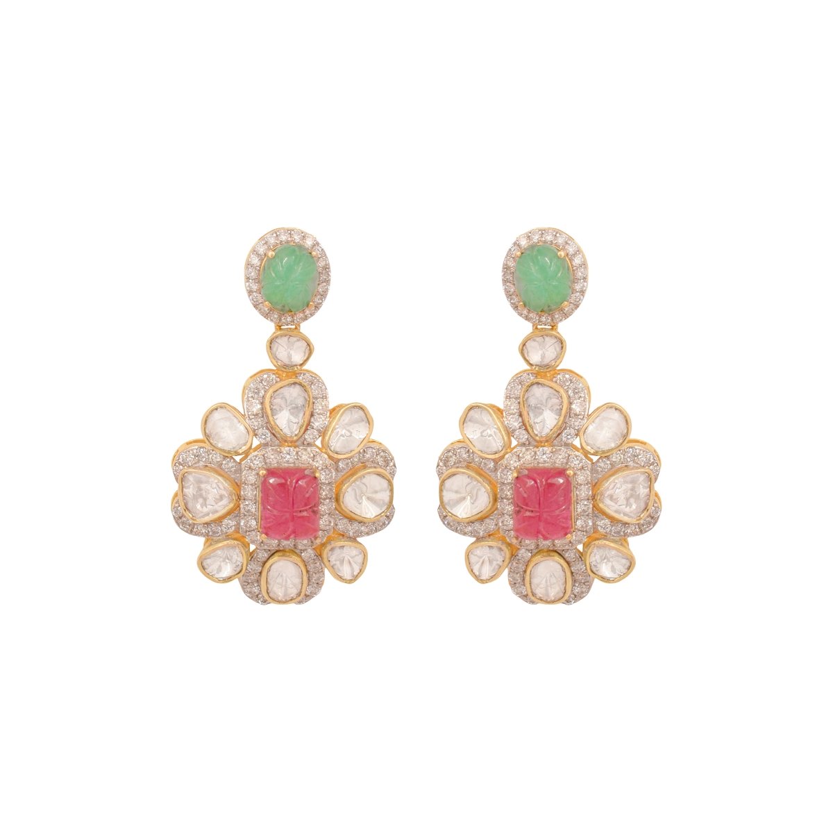 Traditional Polki earrings laid on ivory velvet with gold and ruby inlay work visible.