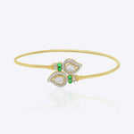 9K gold open ended bracelet featuring twin mango silhouettes with clear uncut stones.