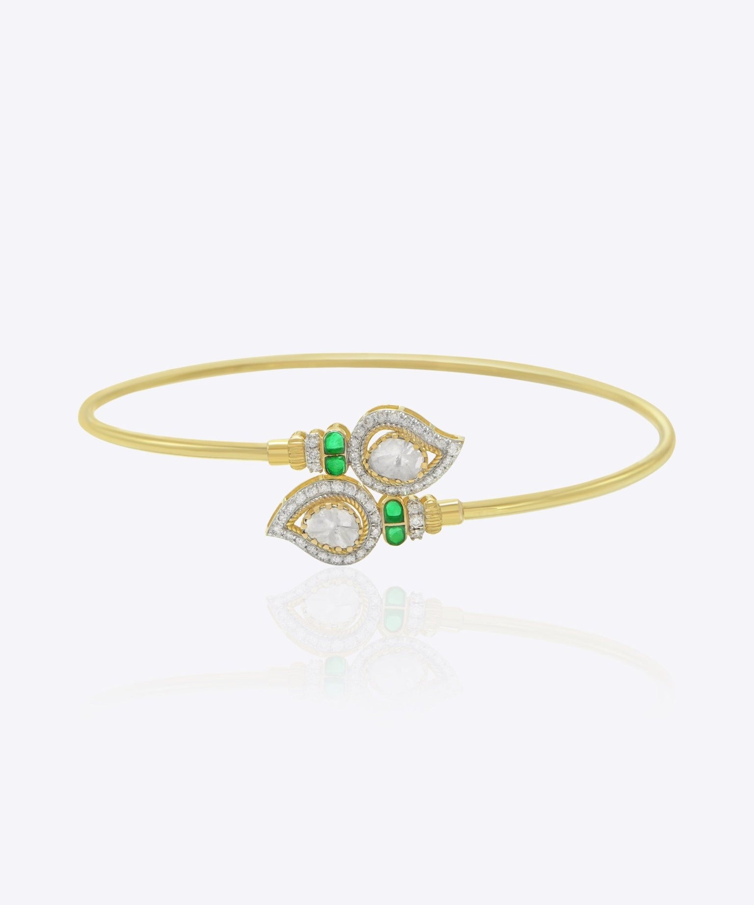 9K gold open ended bracelet featuring twin mango silhouettes with clear uncut stones.