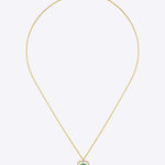 14K gold pendant with a vivid emerald in a clean geometric design