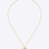 14K gold pendant with a vivid emerald in a clean geometric design