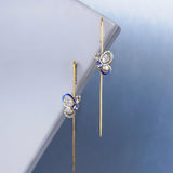 14k gold Mystic Wing earpins with Polki, diamonds, and tanzanite in a butterfly-wing design.