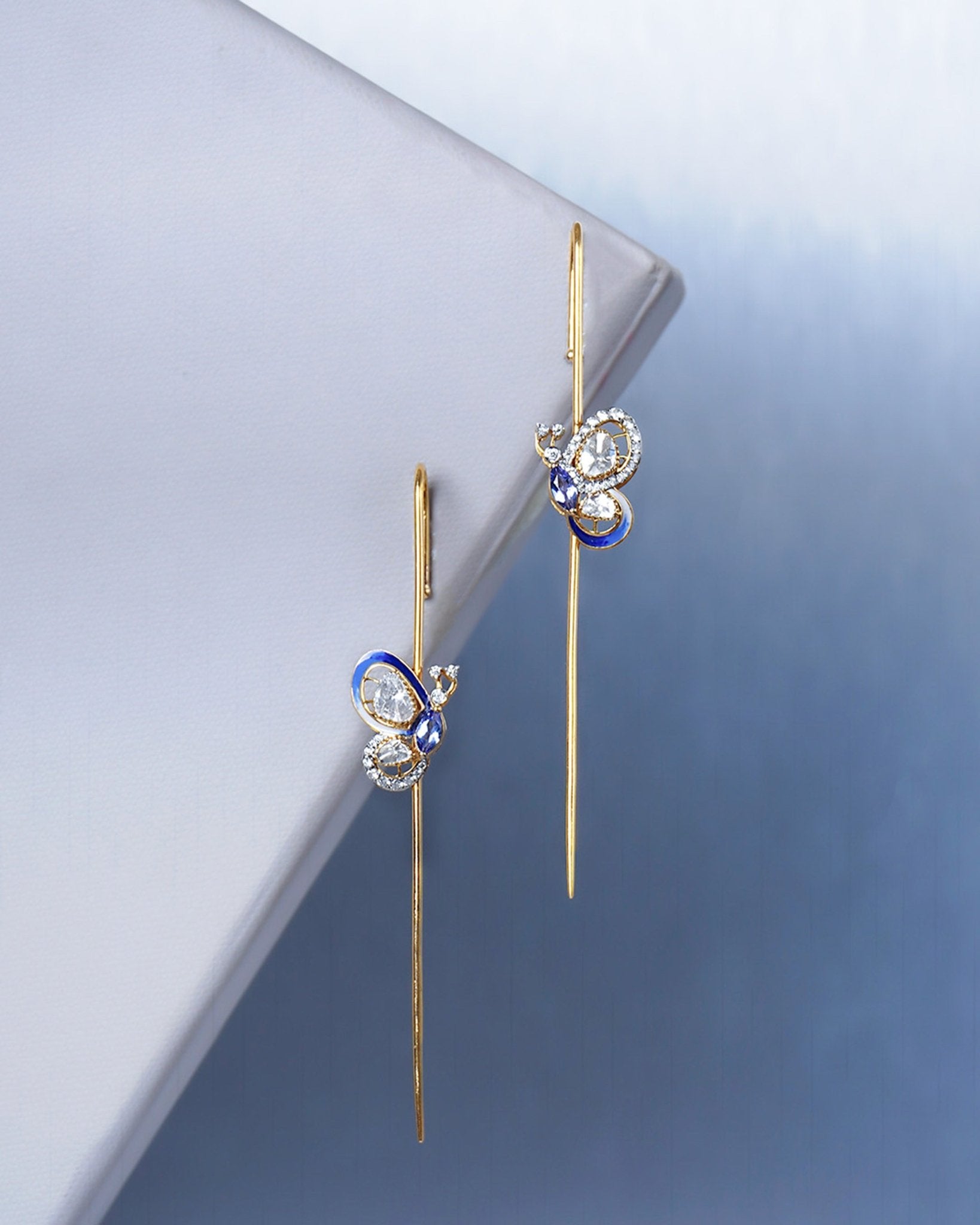 14k gold Mystic Wing earpins with Polki, diamonds, and tanzanite in a butterfly-wing design.
