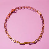 18K solid gold paper clip chain bracelet, shown worn solo for an everyday minimal look.